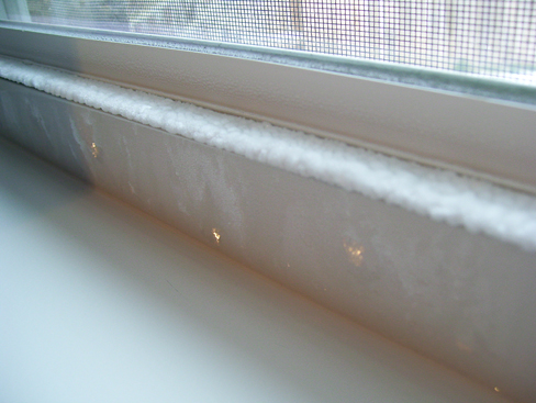 Ice formed on the inside of window sill